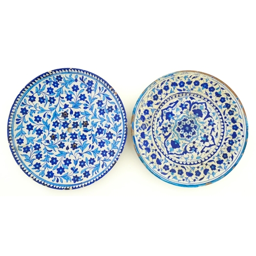 209 - Two Iznik pottery chargers decorated with blue and turquoise flowers and foliage. Largest approx. 15... 