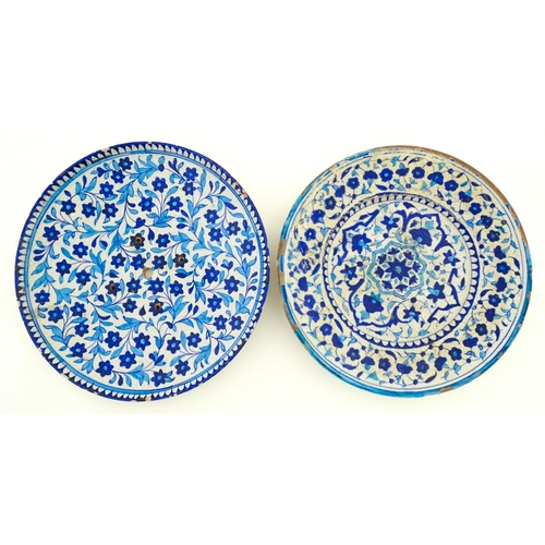209 - Two Iznik pottery chargers decorated with blue and turquoise flowers and foliage. Largest approx. 15... 