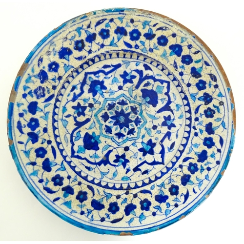 209 - Two Iznik pottery chargers decorated with blue and turquoise flowers and foliage. Largest approx. 15... 