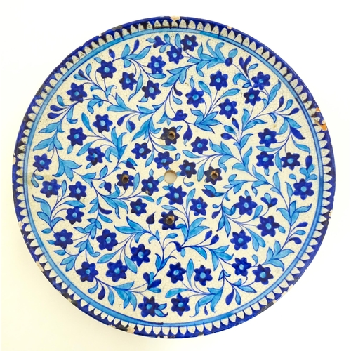 209 - Two Iznik pottery chargers decorated with blue and turquoise flowers and foliage. Largest approx. 15... 