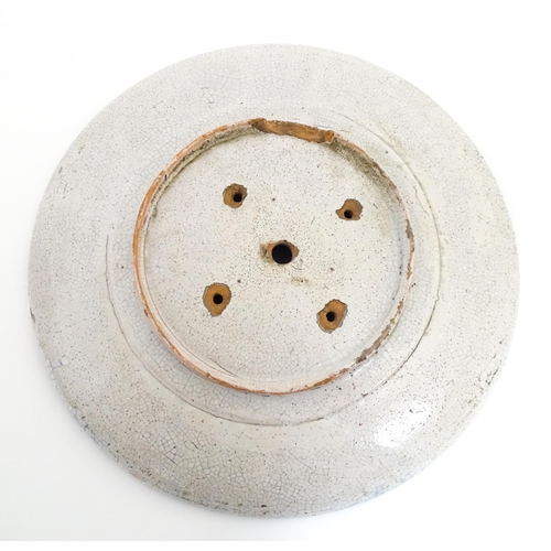 209 - Two Iznik pottery chargers decorated with blue and turquoise flowers and foliage. Largest approx. 15... 