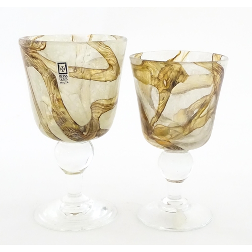 298 - Two Mdina glass earthtones drinking glasses of goblet form. One bearing Mdina label. Largest approx.... 