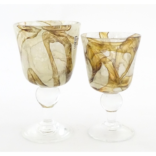 298 - Two Mdina glass earthtones drinking glasses of goblet form. One bearing Mdina label. Largest approx.... 