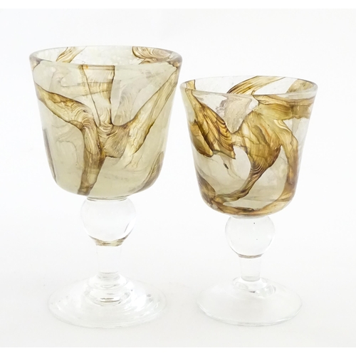 298 - Two Mdina glass earthtones drinking glasses of goblet form. One bearing Mdina label. Largest approx.... 