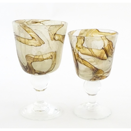 298 - Two Mdina glass earthtones drinking glasses of goblet form. One bearing Mdina label. Largest approx.... 