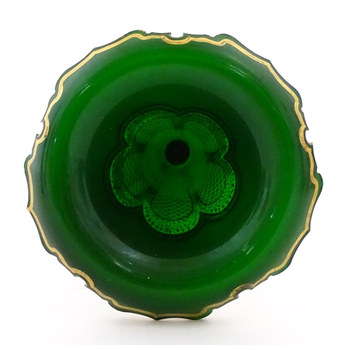 304 - A Bohemian green glass vase of flared form with white overlay and gilt detail. Approx. 12 1/4