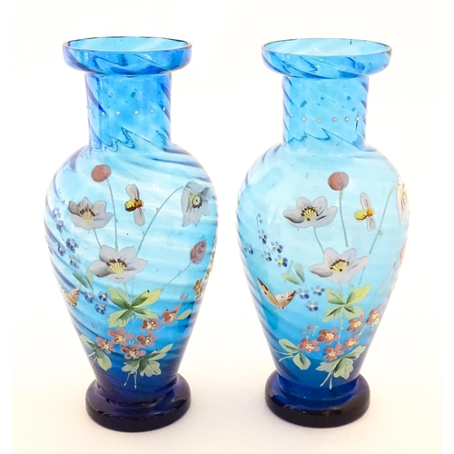 305 - A pair of Victorian blue glass vases with hand painted floral decoration. Approx. 10