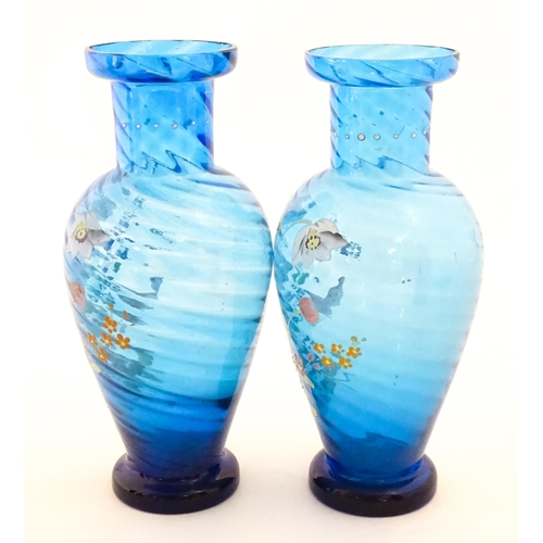 305 - A pair of Victorian blue glass vases with hand painted floral decoration. Approx. 10