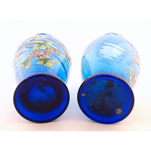 305 - A pair of Victorian blue glass vases with hand painted floral decoration. Approx. 10