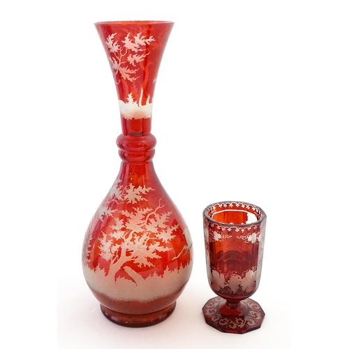 306 - A Bohemian red glass carafe / vase with etched stag decoration. Together with a French ruby glass go... 