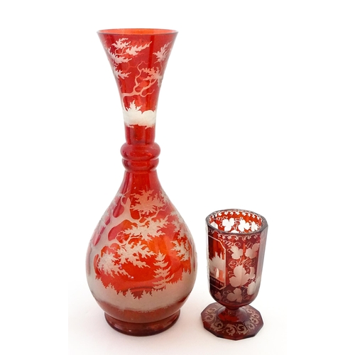306 - A Bohemian red glass carafe / vase with etched stag decoration. Together with a French ruby glass go... 