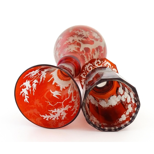 306 - A Bohemian red glass carafe / vase with etched stag decoration. Together with a French ruby glass go... 