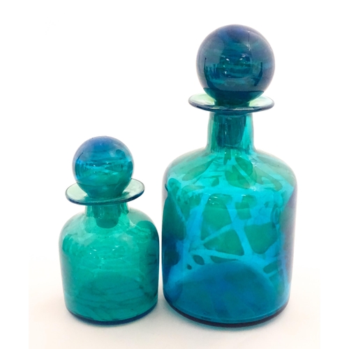 309 - A large Mdina blue glass decanter. Together with a smaller example. Both signed Mdina under. Largest... 
