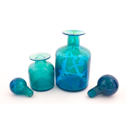 309 - A large Mdina blue glass decanter. Together with a smaller example. Both signed Mdina under. Largest... 