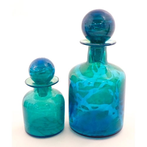 309 - A large Mdina blue glass decanter. Together with a smaller example. Both signed Mdina under. Largest... 