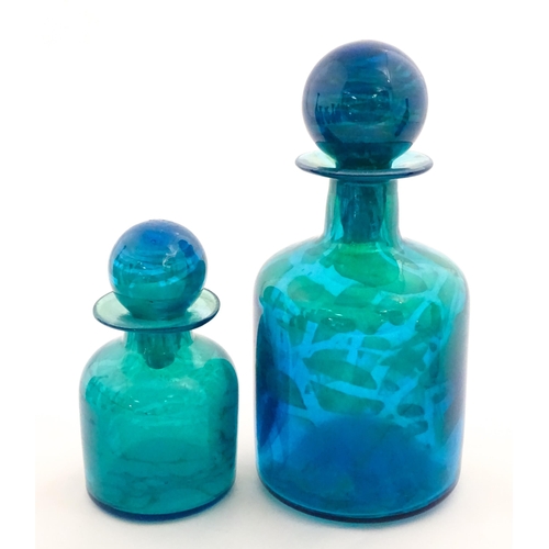 309 - A large Mdina blue glass decanter. Together with a smaller example. Both signed Mdina under. Largest... 