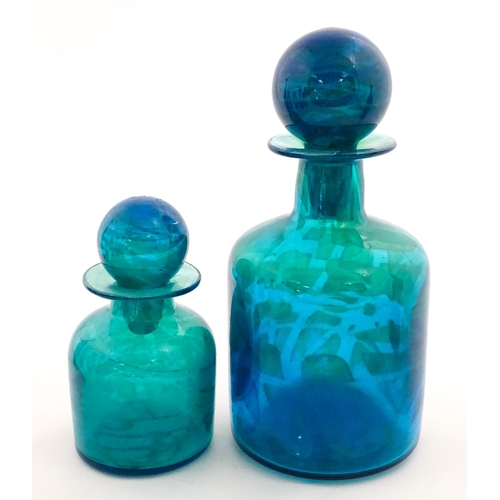 309 - A large Mdina blue glass decanter. Together with a smaller example. Both signed Mdina under. Largest... 