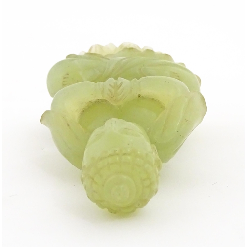 1023 - A Chinese jade coloured soapstone carving modelled as a seated Buddha with hands in prayer on a styl... 