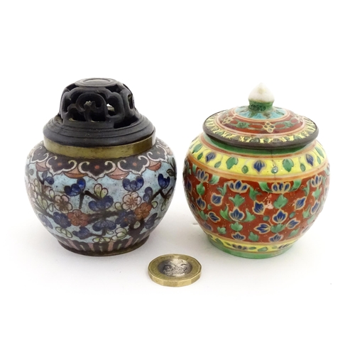 1034 - A small Oriental cloisonne pot with floral and foliate decoration. Together with a small Chinese cer... 