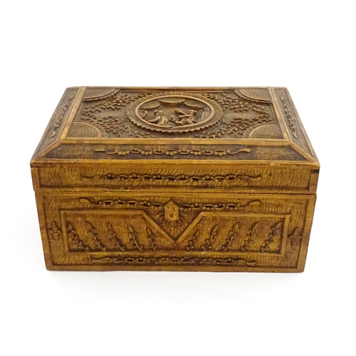 1035 - A Chinese carved sandalwood box decorated with central roundel depicting two figures bordered by fol... 