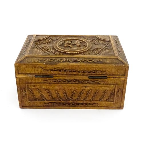 1035 - A Chinese carved sandalwood box decorated with central roundel depicting two figures bordered by fol... 