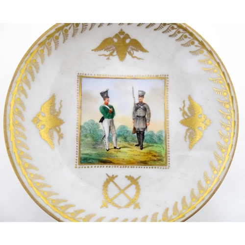 222 - Two Polish Korzec tea cups and saucers with hand painted decoration depicting 18thC Infantry soldier... 