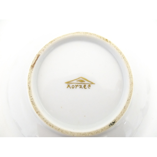 222 - Two Polish Korzec tea cups and saucers with hand painted decoration depicting 18thC Infantry soldier... 