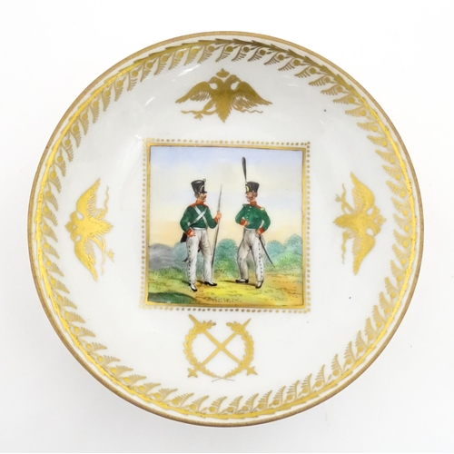 222 - Two Polish Korzec tea cups and saucers with hand painted decoration depicting 18thC Infantry soldier... 