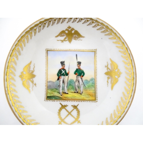222 - Two Polish Korzec tea cups and saucers with hand painted decoration depicting 18thC Infantry soldier... 