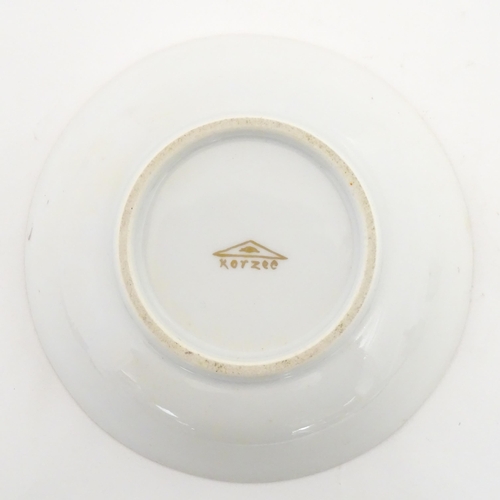 222 - Two Polish Korzec tea cups and saucers with hand painted decoration depicting 18thC Infantry soldier... 