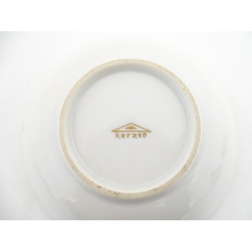 222 - Two Polish Korzec tea cups and saucers with hand painted decoration depicting 18thC Infantry soldier... 