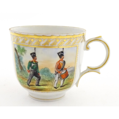 222 - Two Polish Korzec tea cups and saucers with hand painted decoration depicting 18thC Infantry soldier... 