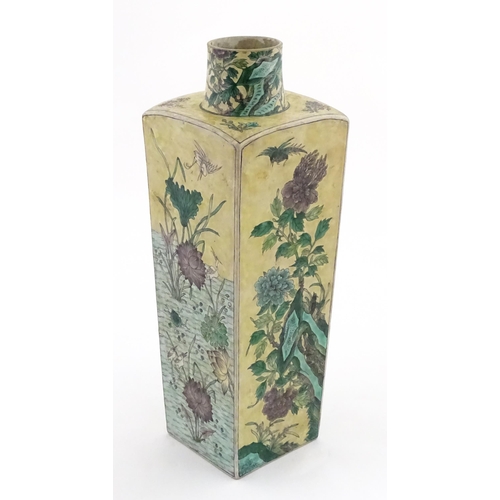 226 - A Chinese vase of squared form with a yellow ground decorated with blossom, peonies, lotus leaves, b... 