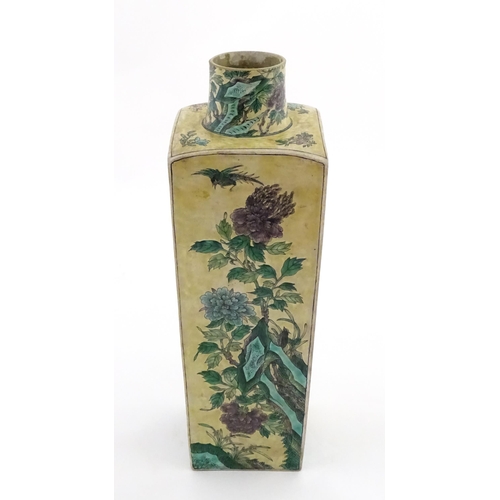 226 - A Chinese vase of squared form with a yellow ground decorated with blossom, peonies, lotus leaves, b... 