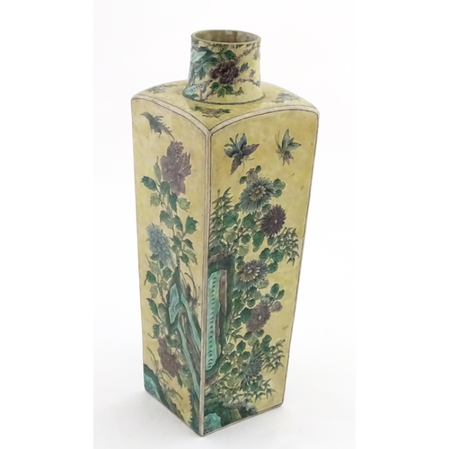 226 - A Chinese vase of squared form with a yellow ground decorated with blossom, peonies, lotus leaves, b... 