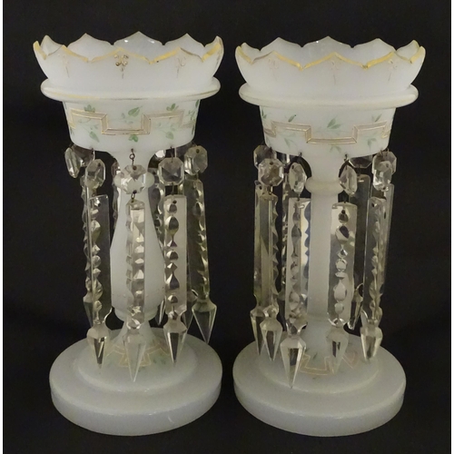303 - Two Victorian opaque glass table lustres with gilt detail and glass lustre drops. Approx. 12 3/4