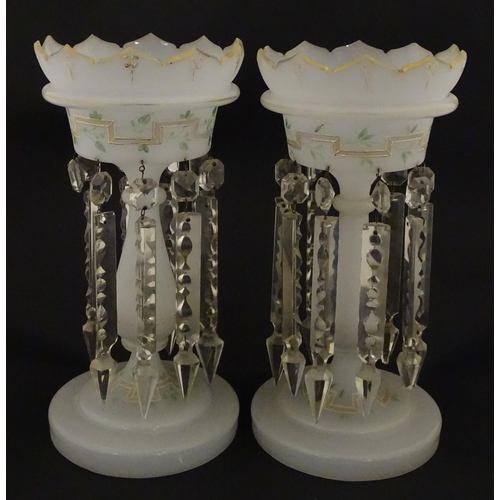 303 - Two Victorian opaque glass table lustres with gilt detail and glass lustre drops. Approx. 12 3/4