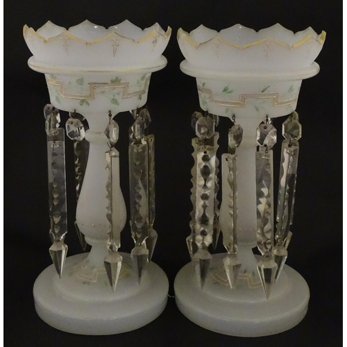 303 - Two Victorian opaque glass table lustres with gilt detail and glass lustre drops. Approx. 12 3/4