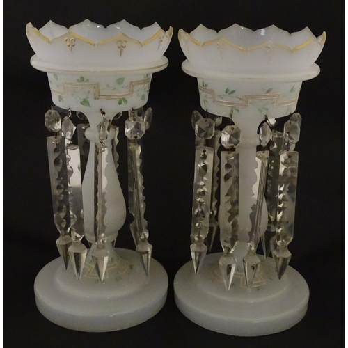 303 - Two Victorian opaque glass table lustres with gilt detail and glass lustre drops. Approx. 12 3/4
