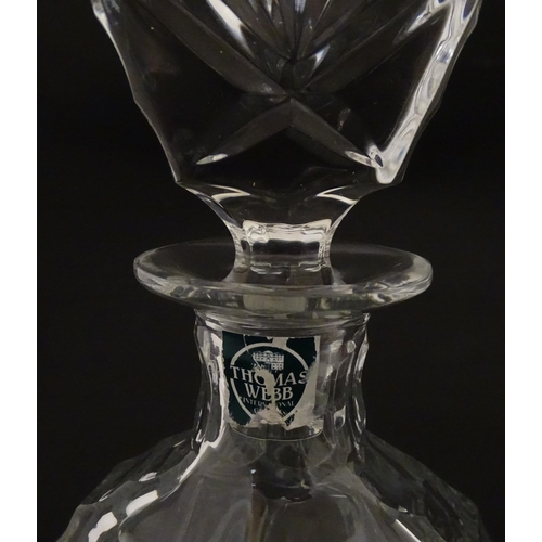 310 - A Stuart Crystal tilted decanter. Together with a Thomas Webb cut crystal decanter. Largest approx. ... 