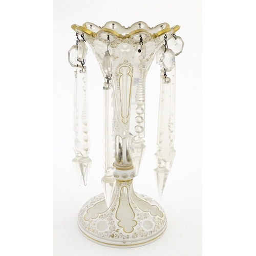 314 - A Victorian glass table lustre with white overlay and gilt detail with glass lustre drops. Approx. 1... 