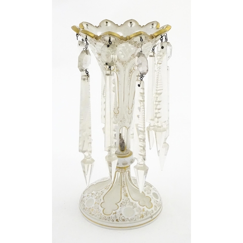 314 - A Victorian glass table lustre with white overlay and gilt detail with glass lustre drops. Approx. 1... 