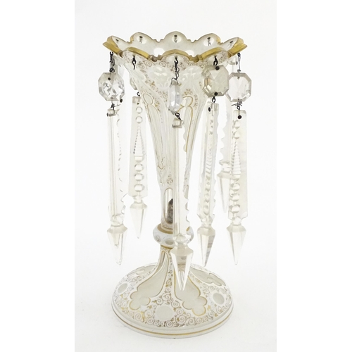314 - A Victorian glass table lustre with white overlay and gilt detail with glass lustre drops. Approx. 1... 