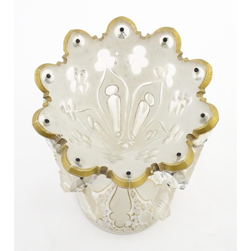 314 - A Victorian glass table lustre with white overlay and gilt detail with glass lustre drops. Approx. 1... 