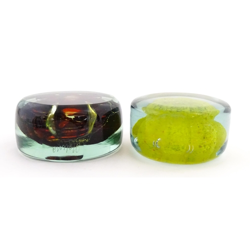 331 - Two Mdina glass paperweights with flower detail. Both signed under. Largest approx. 4 1/2
