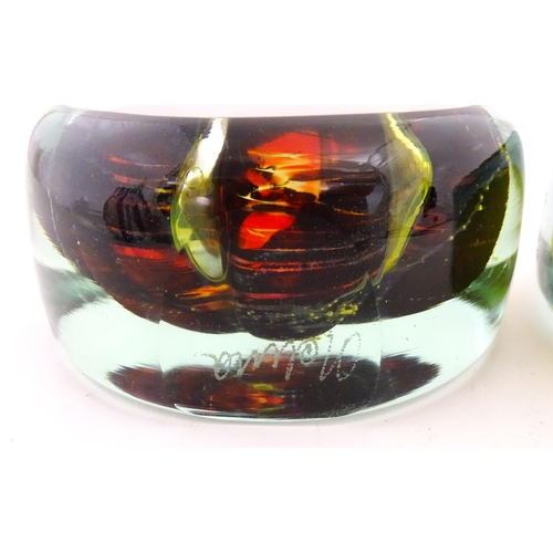 331 - Two Mdina glass paperweights with flower detail. Both signed under. Largest approx. 4 1/2