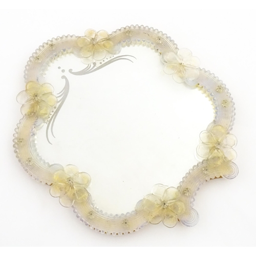 333 - An Italian / Venetian Murano framed mirror with applied glass flower detail. Approx. 13 1/2