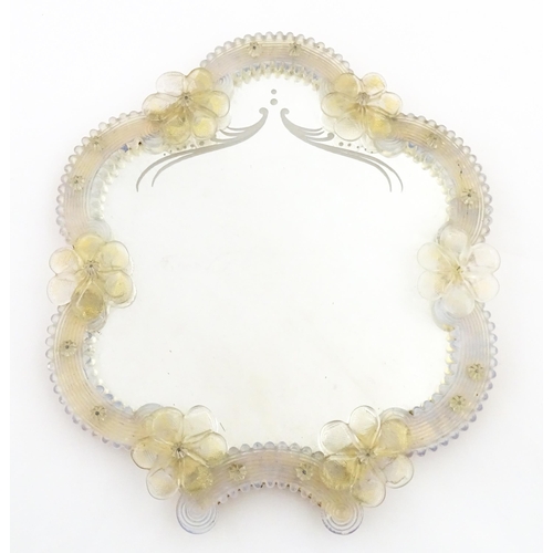 333 - An Italian / Venetian Murano framed mirror with applied glass flower detail. Approx. 13 1/2