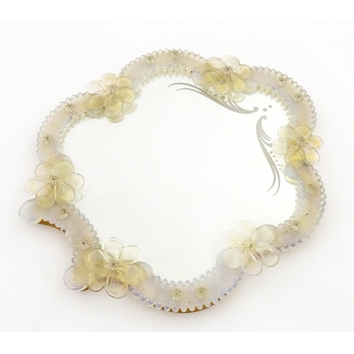 333 - An Italian / Venetian Murano framed mirror with applied glass flower detail. Approx. 13 1/2