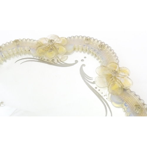 333 - An Italian / Venetian Murano framed mirror with applied glass flower detail. Approx. 13 1/2